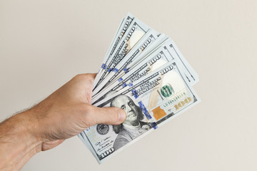 Fan of 100 Dollars notes in male hand