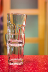 two empty glasses on a red bar counter