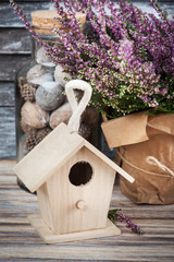 Pink heather and bird house
