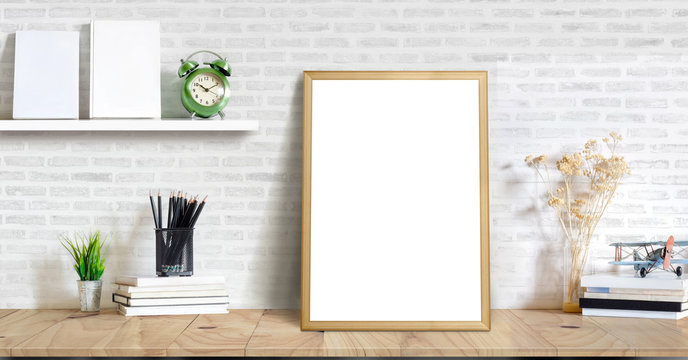 Mock up poster or photo frame and supplies on table hipster minimalism loft desk space, copy space