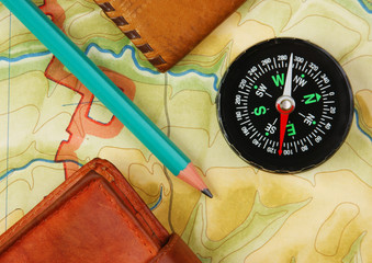 compass wallet and passport on the old map