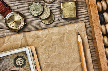 Fototapeta na wymiar Old notes and coins and abacus on a wooden table