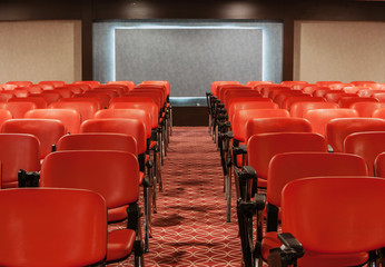 Obraz premium rows of red chairs in empty conference hall