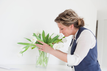 Woman smelling on white tulips