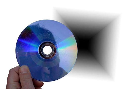 hand holding cd or dvd disc close up and black hole background