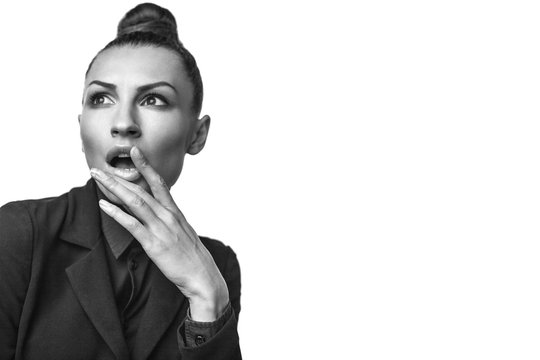 Beautiful woman in fashion suite is surprised. model with beautiful hands looks surprised, flightendly. Hair in a bun. isolated on white background. free space. high resolution 