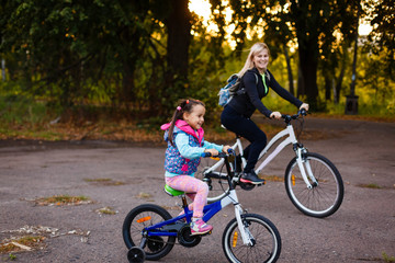 Fototapeta premium Mother and daughter were cycling at the park 