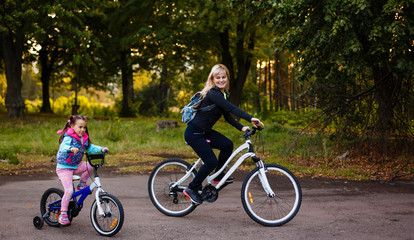 Mother and daughter were cycling at the park 
