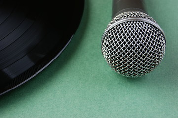 microphone and old vinyl record  on a green background