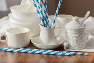 Set of white empty tableware with striped tubules