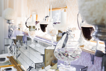 Delicious and tasty dessert table with cupcakes shots at reception closeup