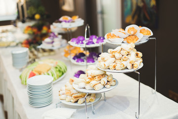 Delicious sweets on wedding candy buffet with desserts, cupcakes