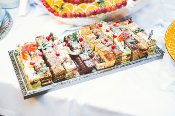 Delicious sweets on wedding candy buffet with desserts, cupcakes