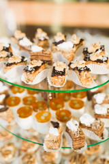 Delicious sweets on wedding candy buffet with desserts, cupcakes