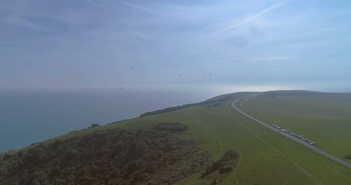 Aerial view of paragliders at Beachy Head, Southern England, with the sea in the background