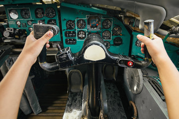 The hands that hold the helm of the plane
