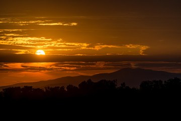 Beautiful sunset sky. Sky Background. The setting sun in a cloudy sky background