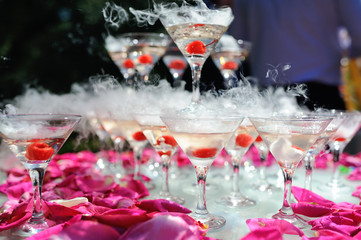 champagne slide with dry ice. Pyramid from glasses with alcohol and smoke. Outdoor bar