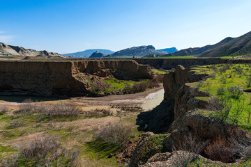 Mountain river with yellow water