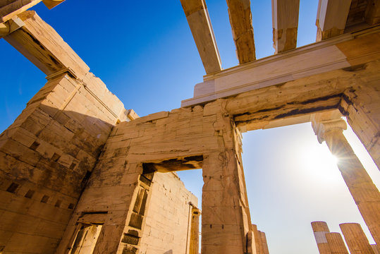 Entrance to the Acropolis hill in Athens during the sunset. Ruins of the Acropolis hill in Greece.