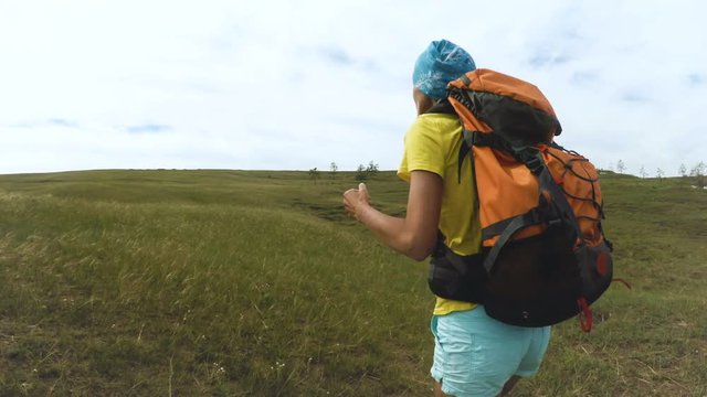 woman hiker trekking. Wearing backpack. Healthy lifestyle Caucasian girl in Siberia in summer, Russia