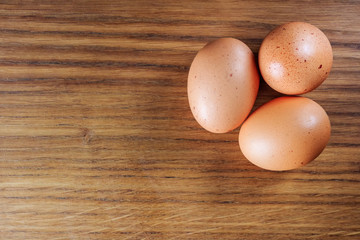 Fresh, raw chicken eggs on an oak tray. A place for a label.