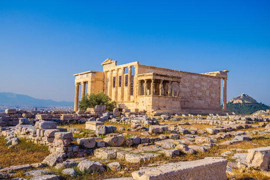 Erechtheion temple in Athens during the sunset. Ruins of the Temple of Erechtheion and Temple of Athene at the Acropolis hill in Greece.