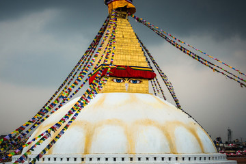 Boudhanath stupa in Kathmandu, Nepal. Stormy clouds in the background.