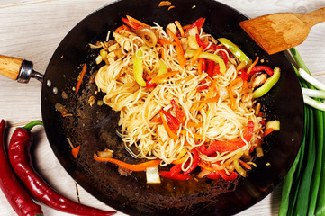 Chinese noodles Udon with vegetables in a frying pan wok