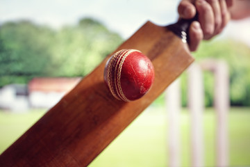 Cricket player hitting a ball