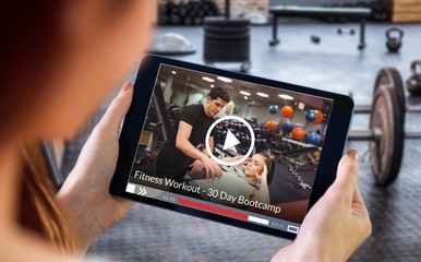 Composite image of finger pointing to tablet