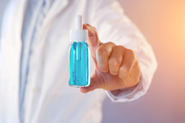 Doctor using flask  on a color background