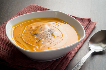 Pumpkin soup on brown background