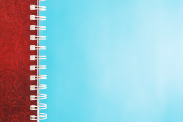 diary with spiral on blue background