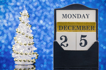 Christmas ornaments with wooden calendar on blue background