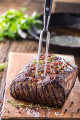 Beef steak. Juicy Rib Eye steak in pan on wooden board with fork