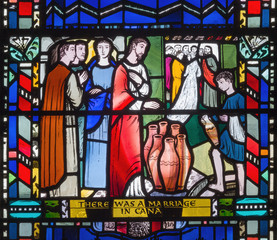 Naklejka na ściany i meble LONDON, GREAT BRITAIN - SEPTEMBER 16, 2017: The stained glass of he Wedding at Cana in church St Etheldreda by Charles Blakeman (1953 - 1953).