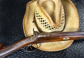 Antique Shotgun and Straw Hat. - obrazy, fototapety, plakaty