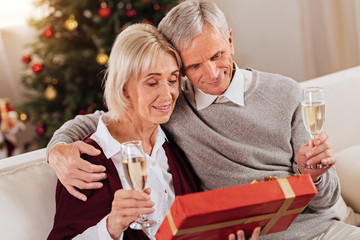 Happy couple sitting together in living-room