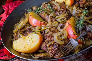 Fried liver with onion apple and herbs.