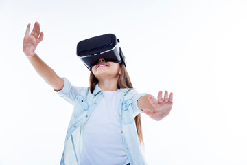 Positive smart girl experiencing virtual reality