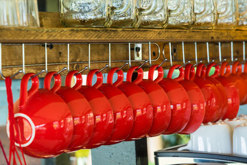 Red coffee cups hanging on the hanger iron to be dry.