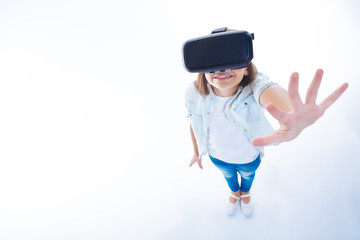Nice cute girl enjoying being in virtual reality