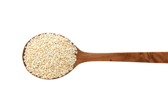 White sesame on wood spoon isolated on white background