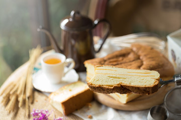 Hot tea cup and butter cake on Sack background