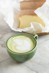 Matcha latte with butter cake breakfast on the marble background