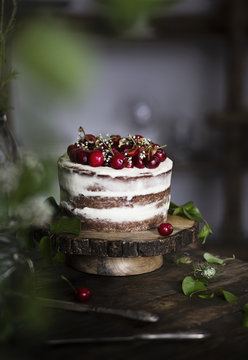 Naked chocolate cake with cherries