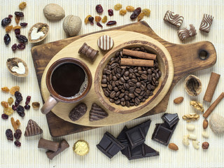 Coffee mug and coffee beans on a wooden board. 