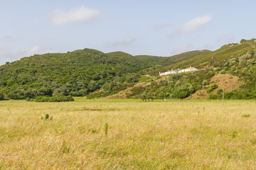 Obraz premium House over mountain and vegetation in Carrapateira