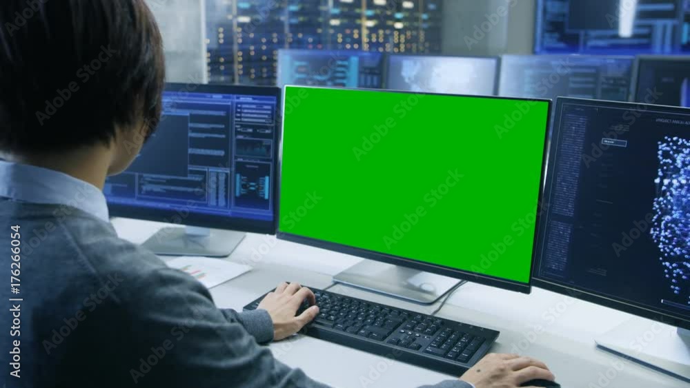 Aufkleber Technical Controller/ Operator Working at His Workstation with Multiple Displays with Mock-up Green Screen. Possible Power Plant/ Airport Dispatcher/ Data Center/ Government Surveillance/ Space.